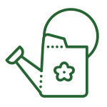 Simple green line drawing of a watering can with a flower design on its side. The can is shown at an angle, with the handle and spout clearly visible.